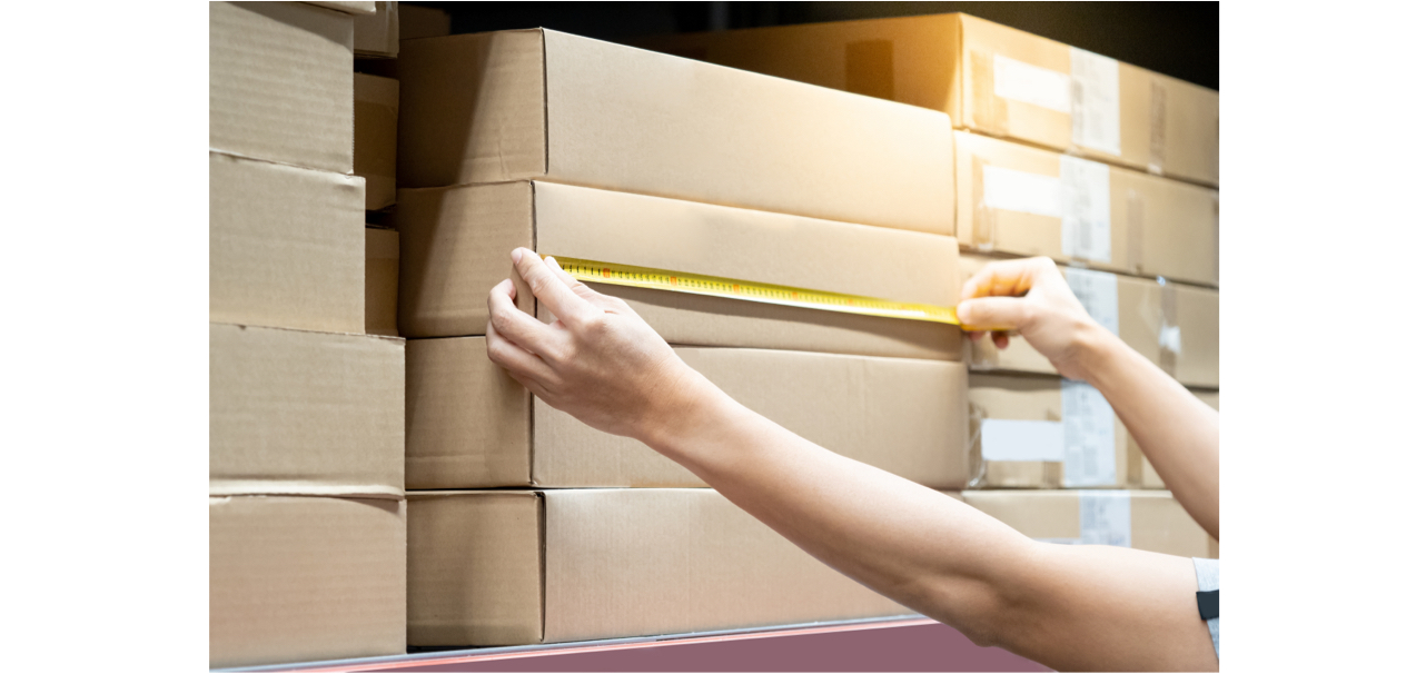 Woman measuring package dimensions with a tape measure