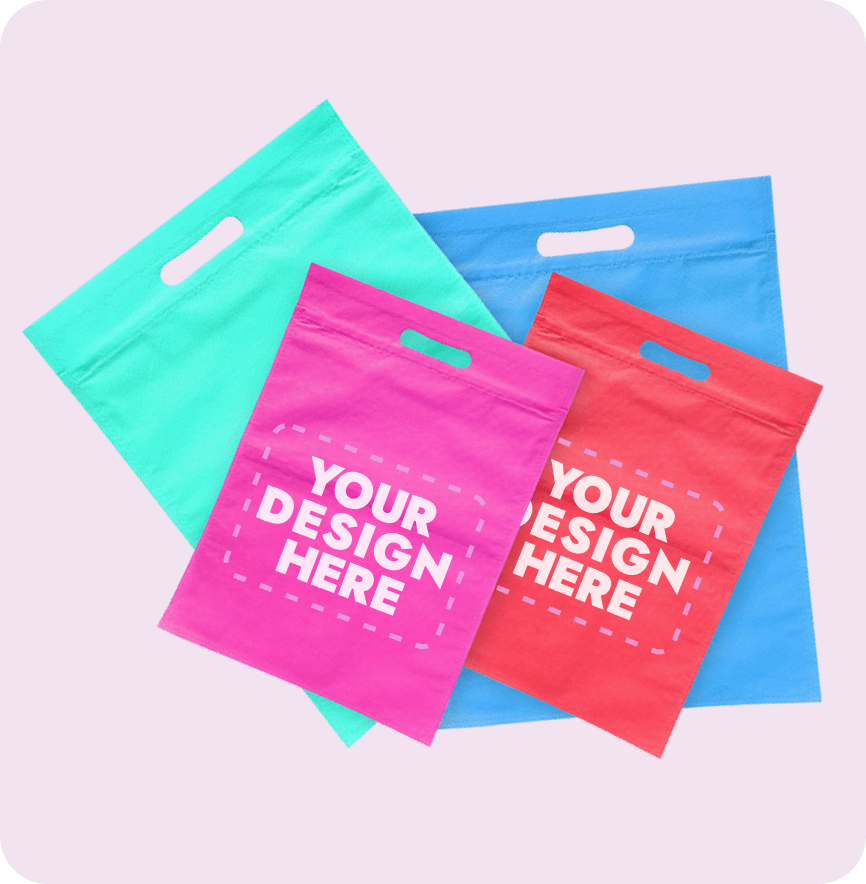 Die Cut Handle Bags Four multicolored die cut handle bags with Your Design Here space at Custom Poly Packaging.
